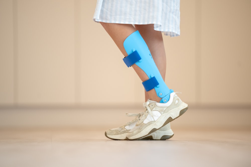 a person with a blue cast on their leg