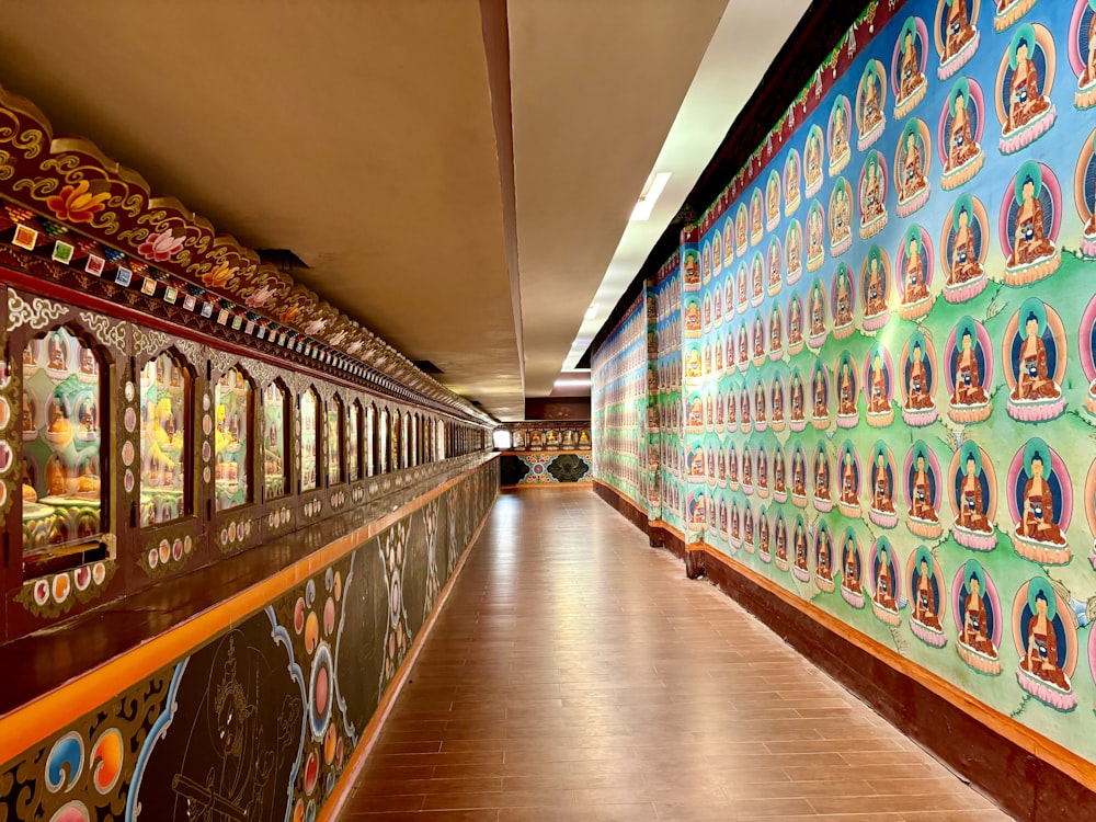 a long hallway with colorful wallpaper and wooden floors