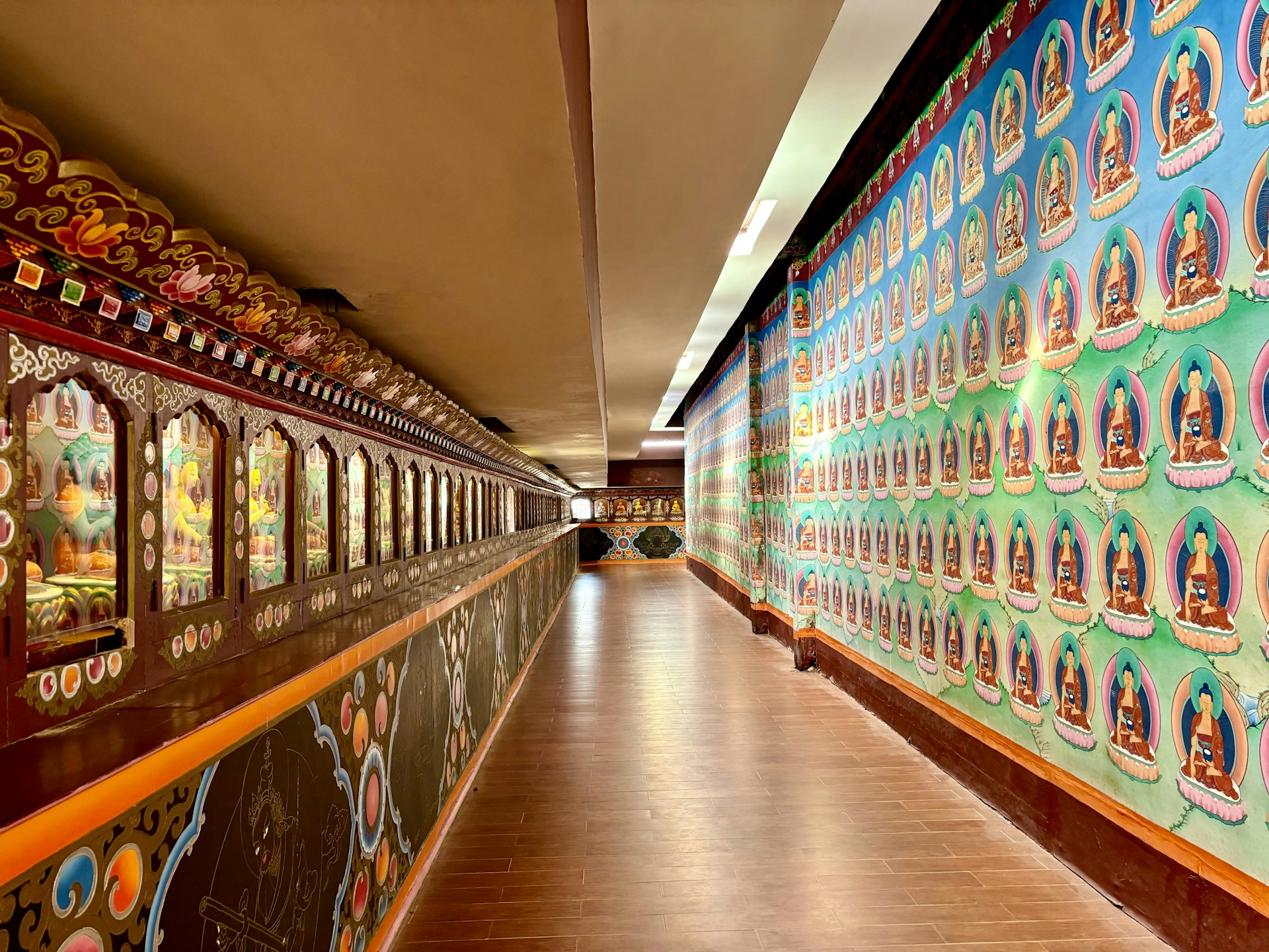 a long hallway with colorful wallpaper and wooden floors