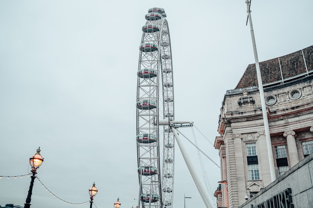 a large ferris wheel sitting next to a tall building