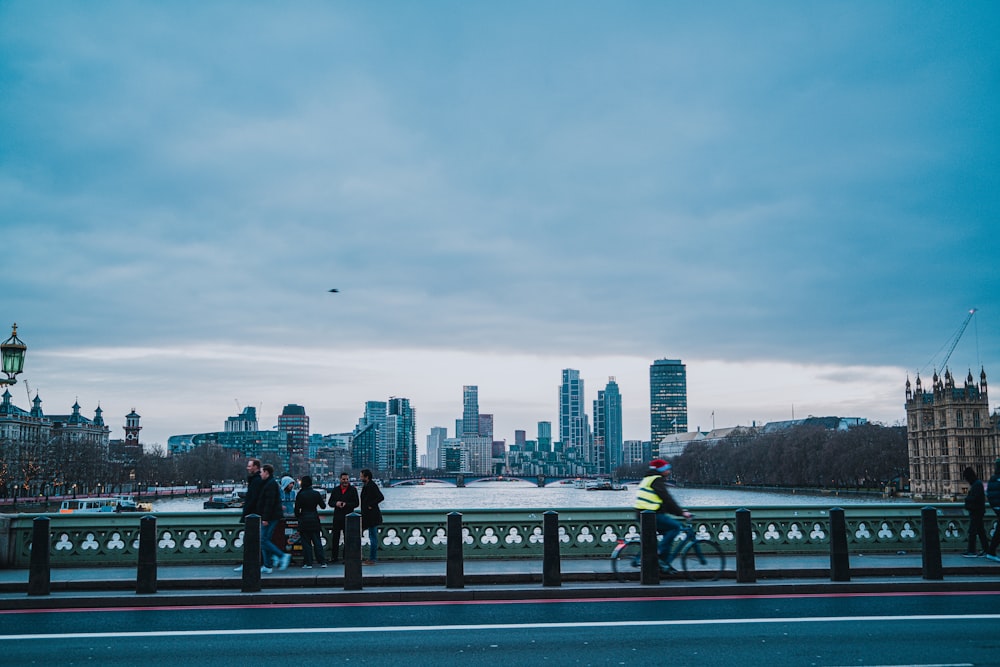 a group of people walking across a bridge