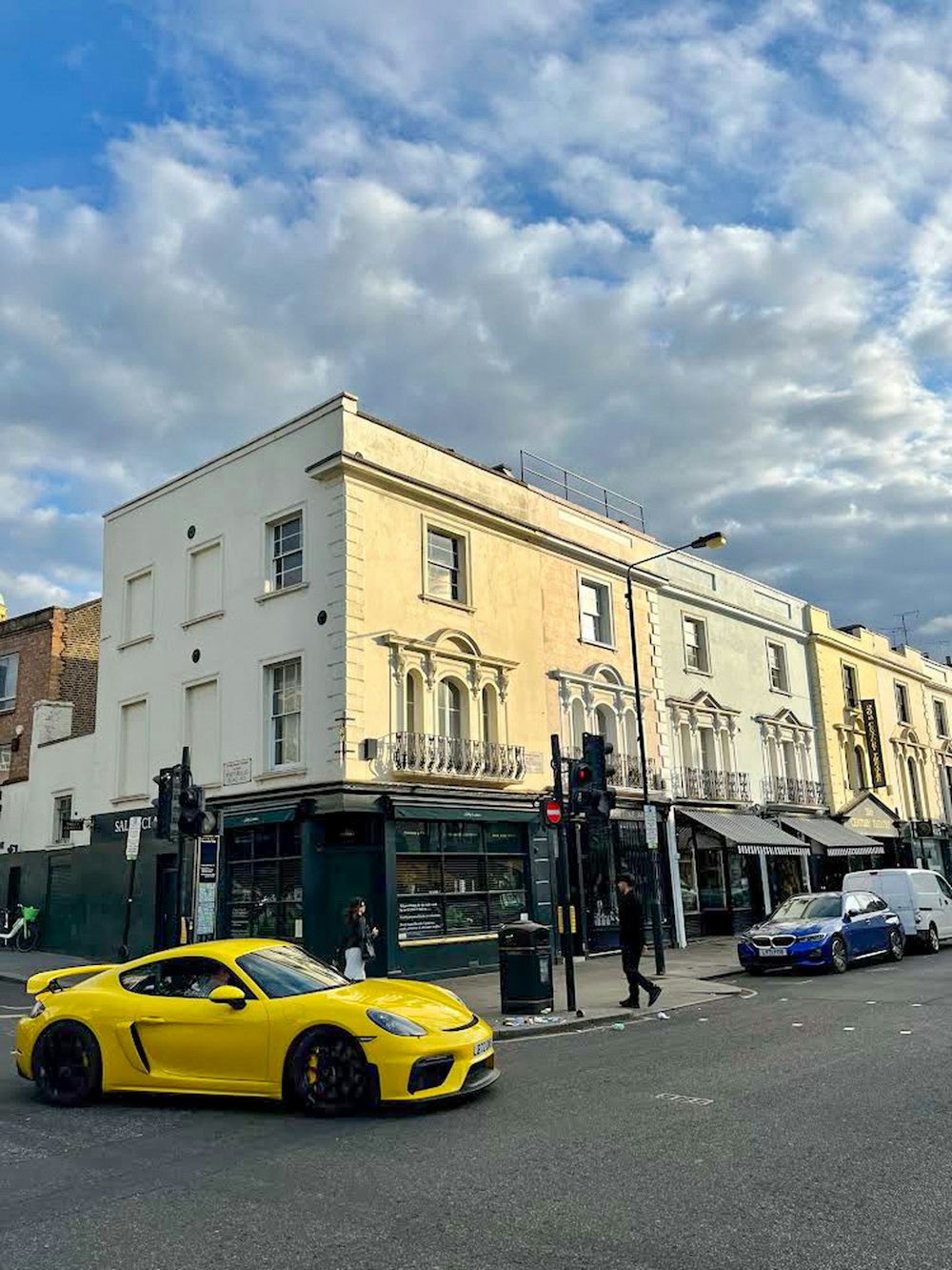 a yellow sports car parked on the side of the road