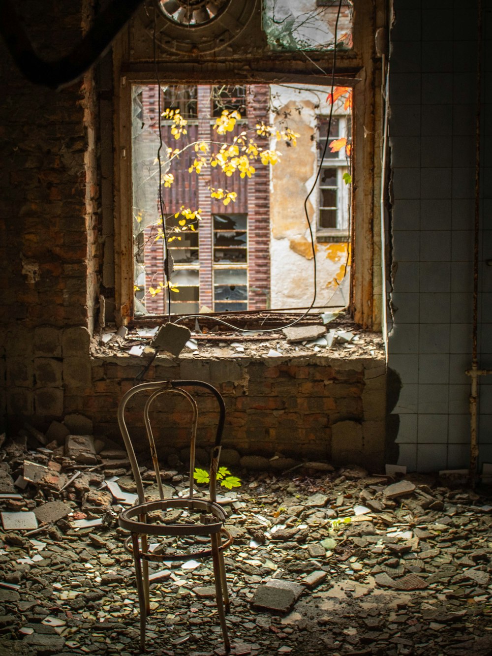 a chair sitting in a room with a broken window