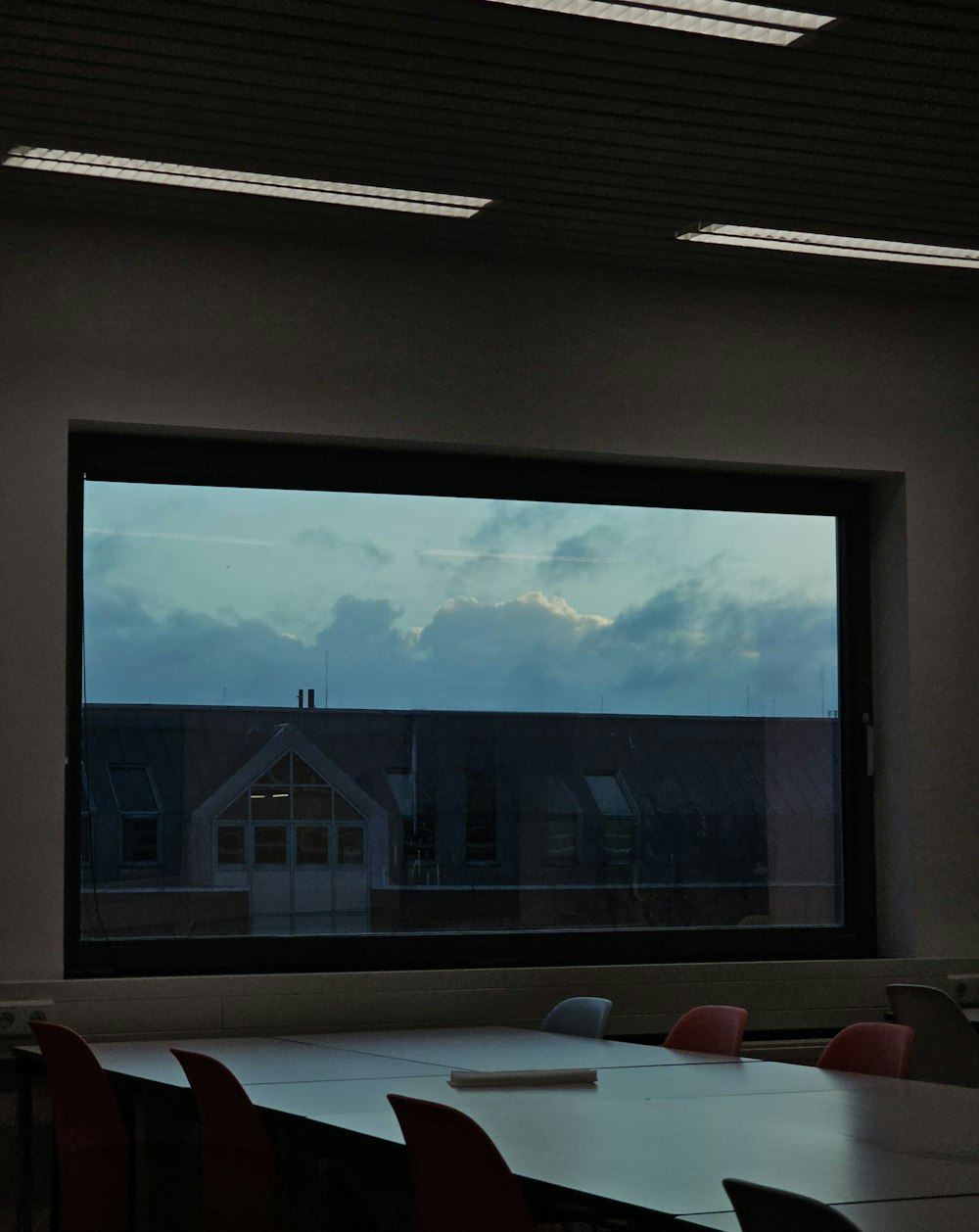 a room with a large window and a view of the sky