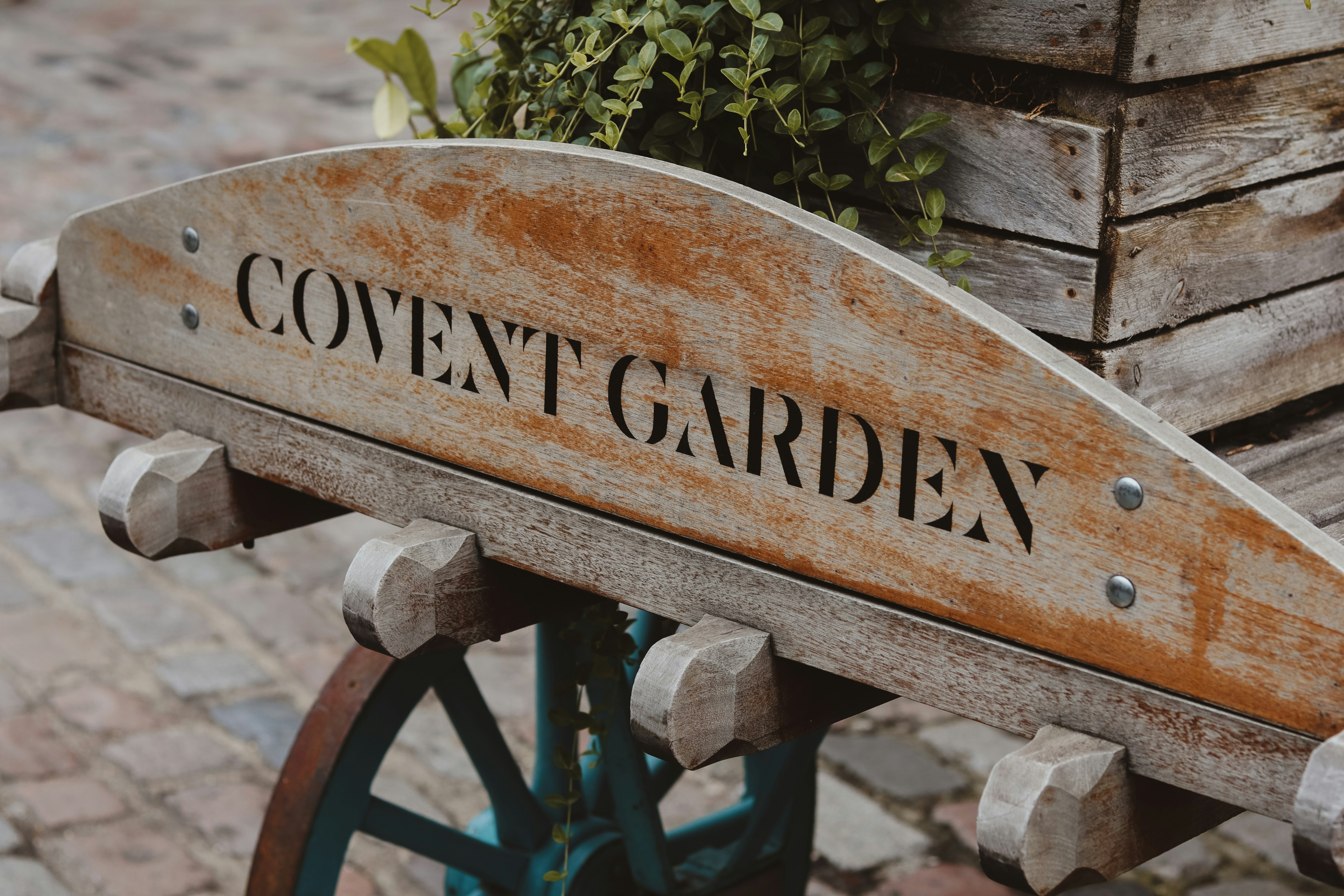 a wooden sign that says covent garden on it