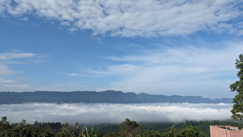 a view of a mountain range with low lying clouds