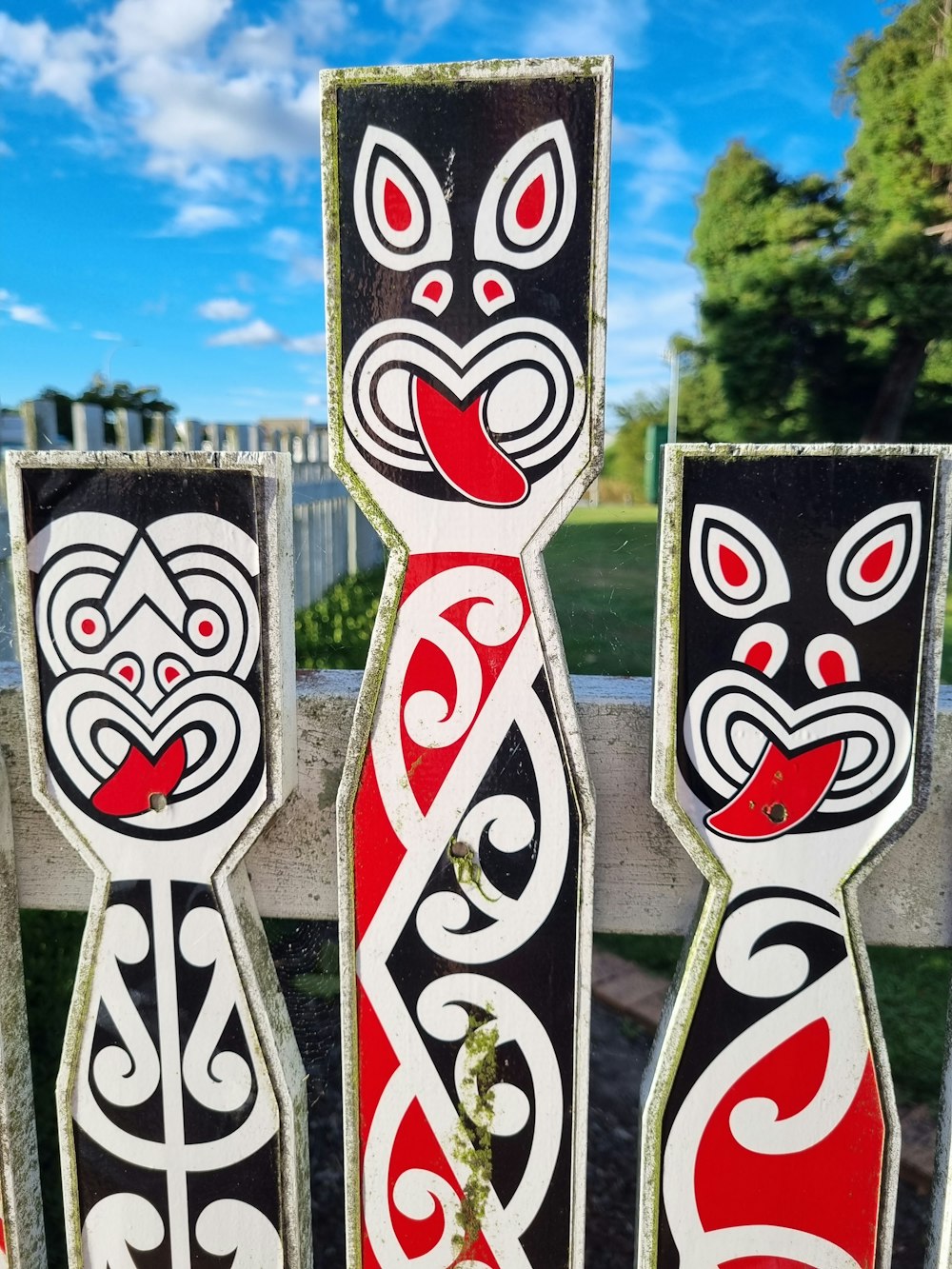 a close up of a wooden fence with designs on it