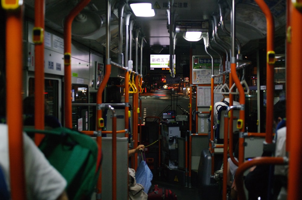 the inside of a public transit bus with lots of luggage