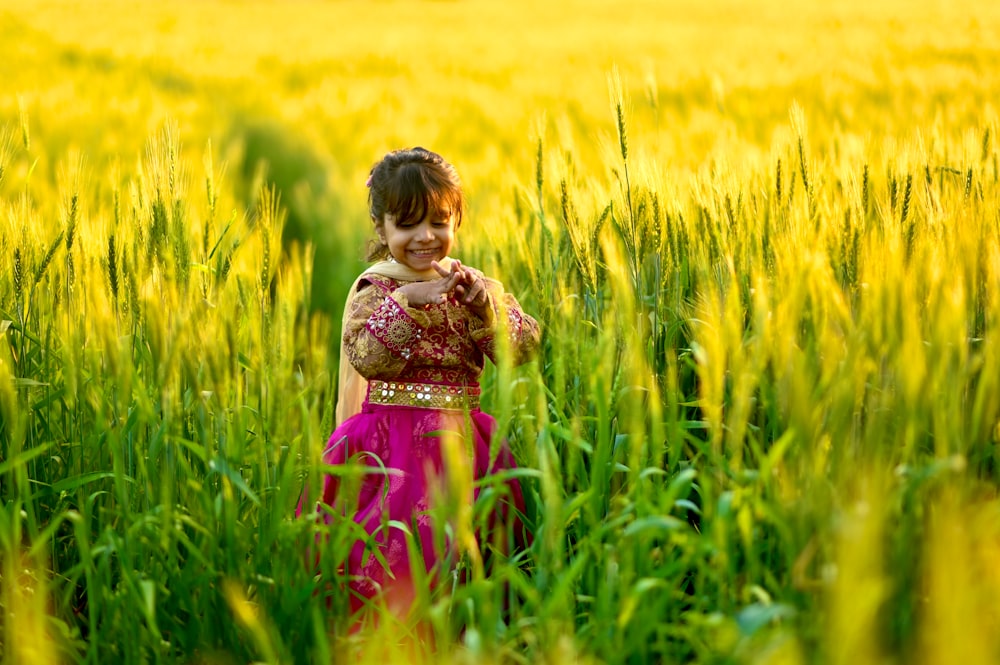a little girl in a field of tall grass