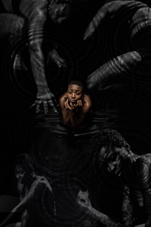 a man is floating in the water with his hands on his face