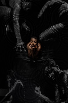 a man is floating in the water with his hands on his face