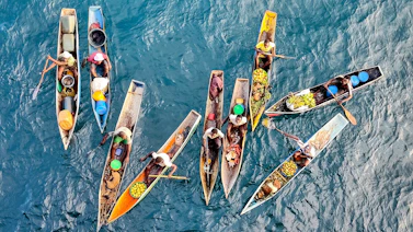a group of boats floating on top of a body of water