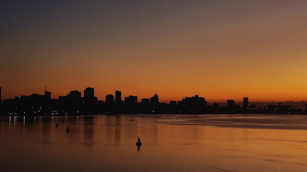 a large body of water with a city in the background