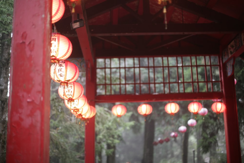 a red building with lanterns hanging from it's roof