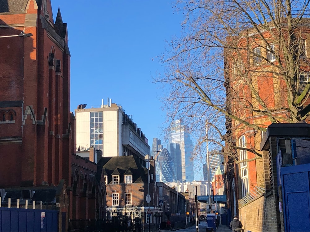 a city street with tall buildings in the background