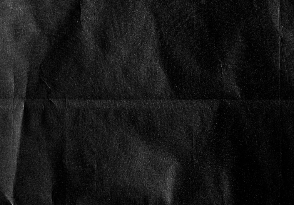 a piece of black paper with a black background