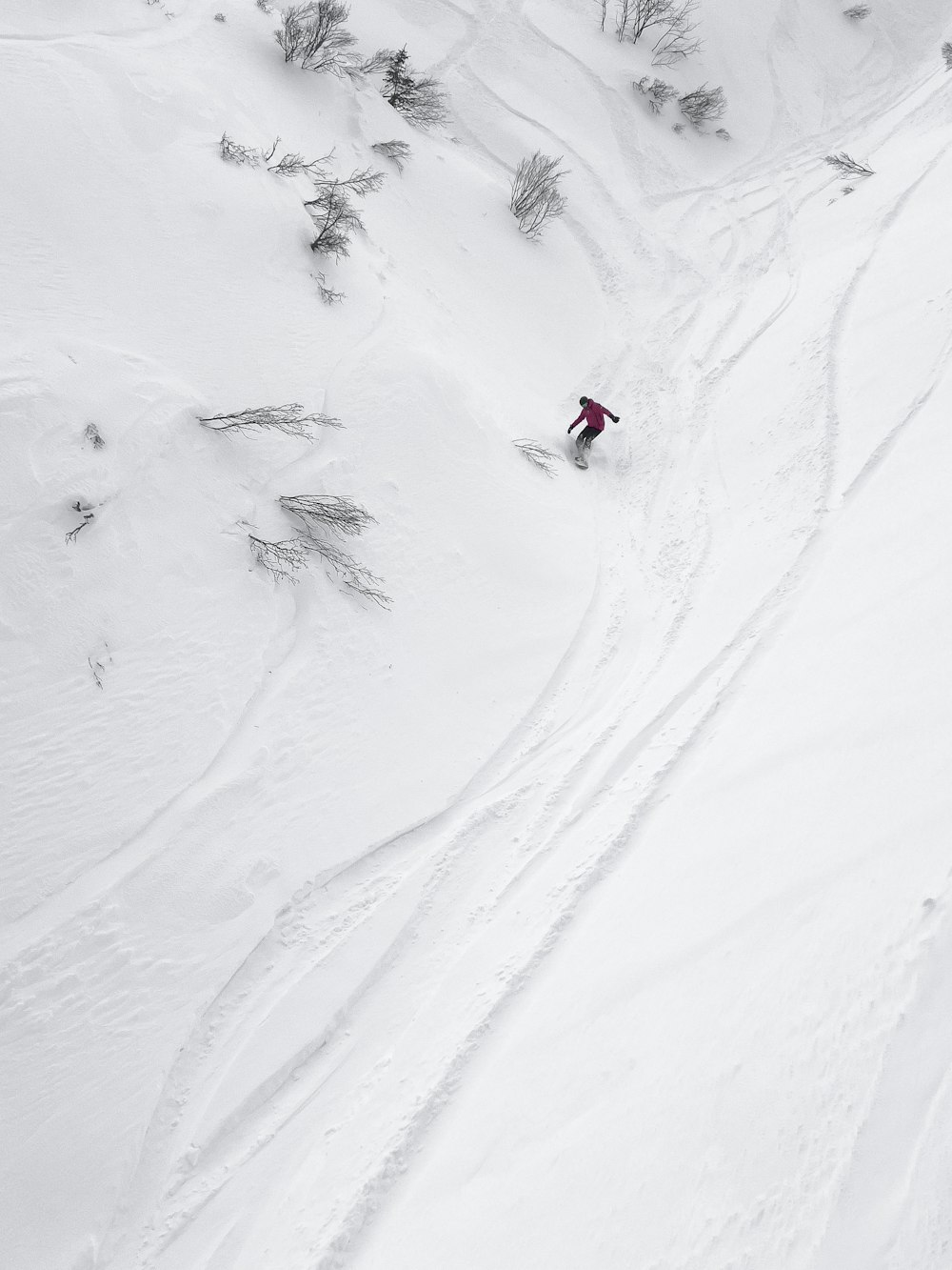 a person riding skis down a snow covered slope