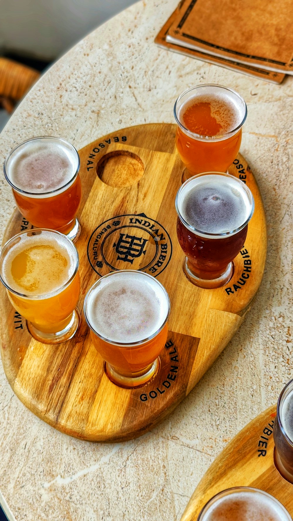 a wooden tray topped with lots of different types of beers