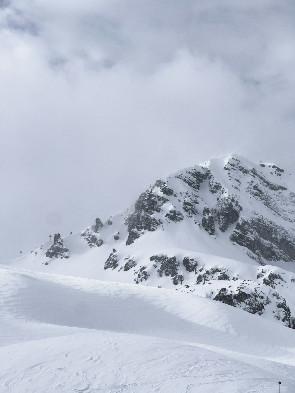 a man riding skis on top of a snow covered slope