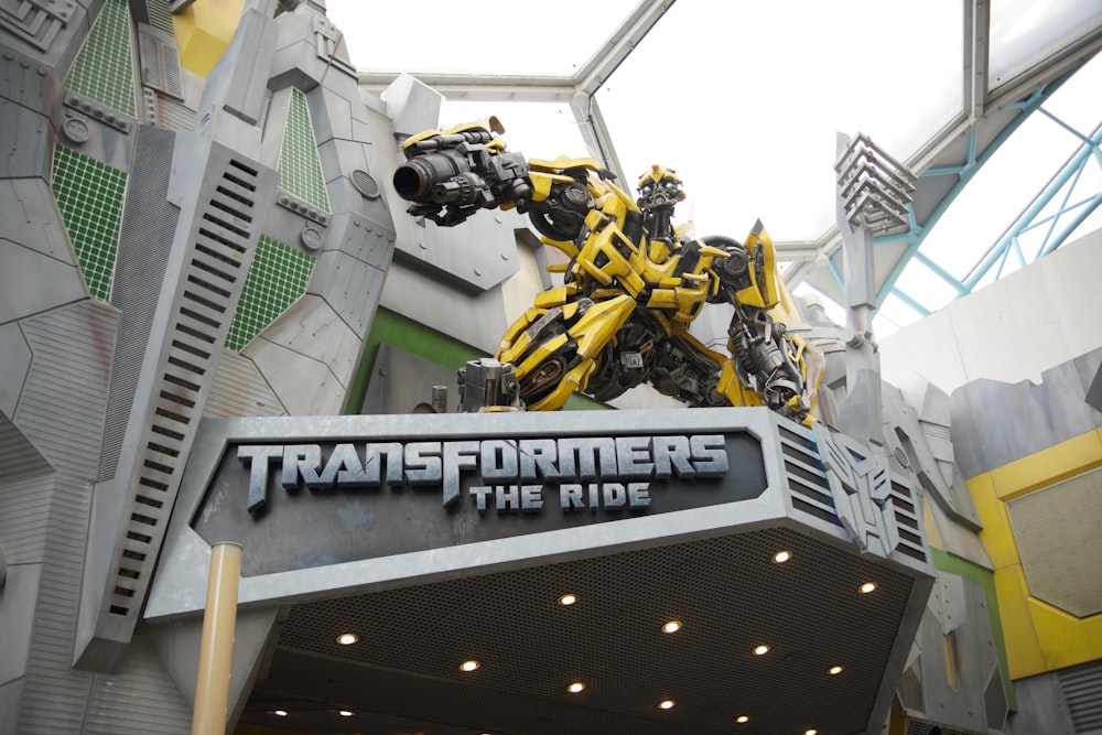 the entrance to a movie theater with a giant robot statue