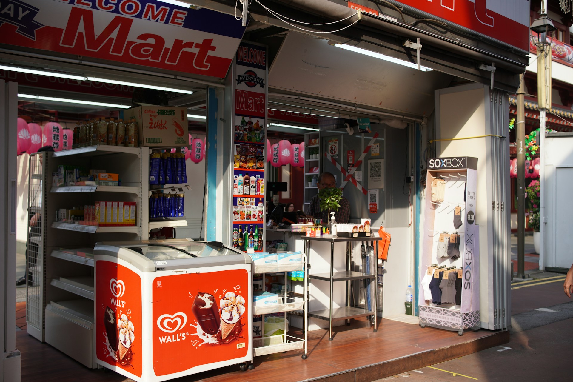 a woman walking past a small store front