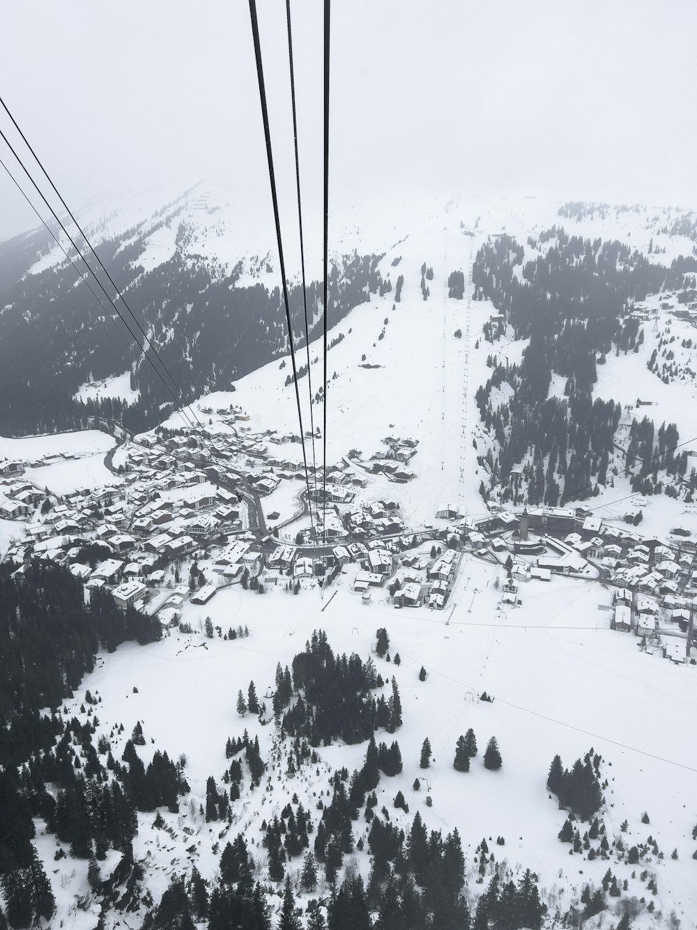 a ski lift going up a snowy mountain