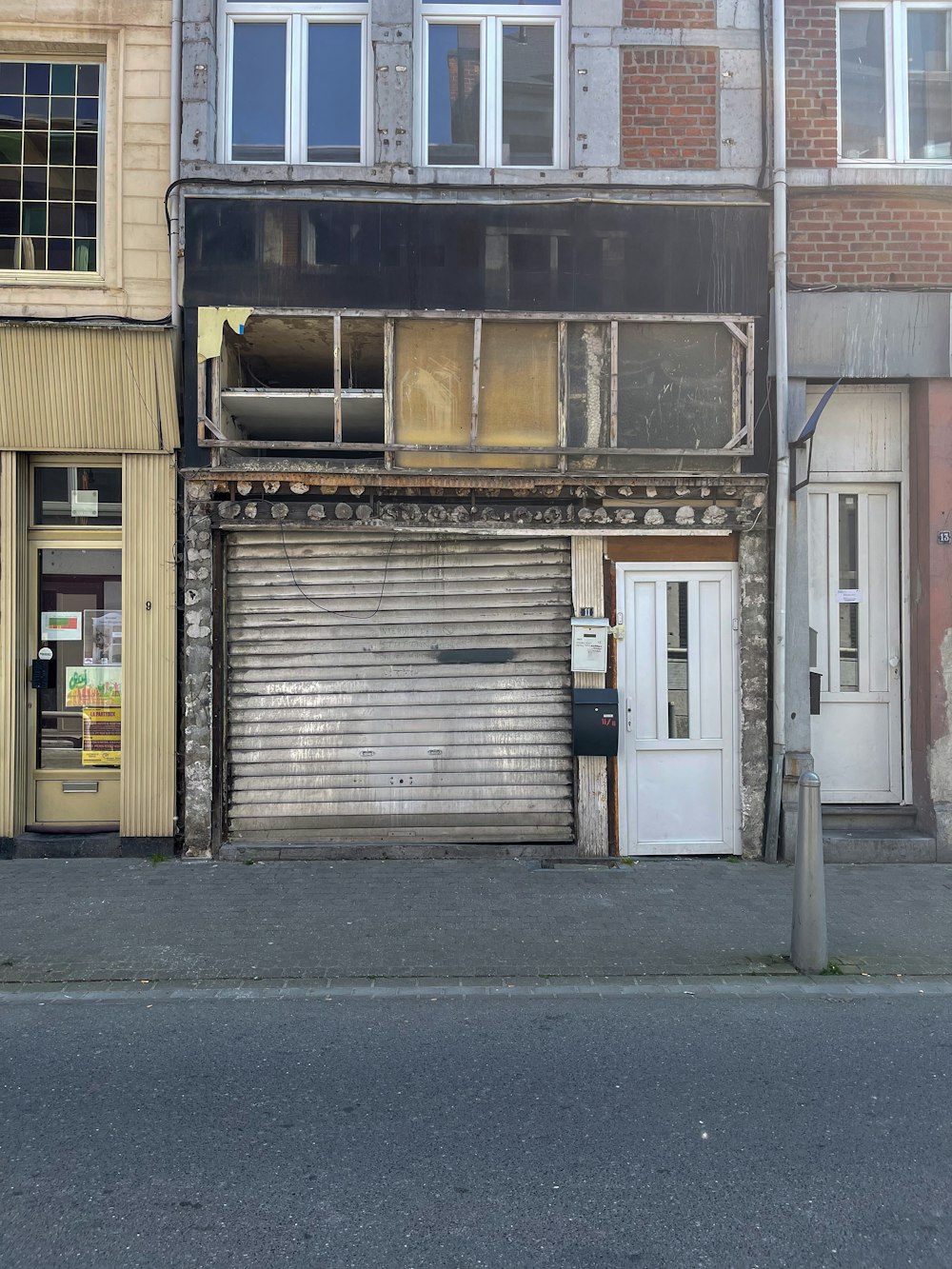 a building with a closed door and a fire hydrant in front of it