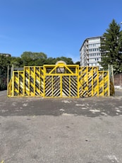 a yellow barricade sitting in the middle of a parking lot