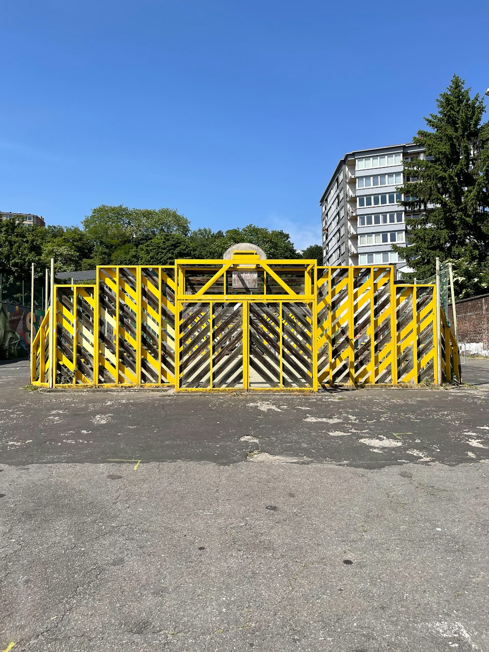 a yellow barricade sitting in the middle of a parking lot