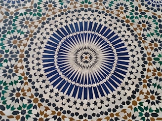 a blue and white tile with a circular design