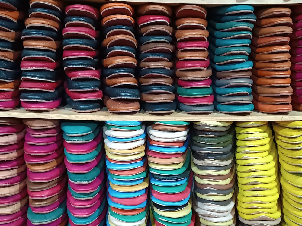 a shelf filled with lots of different colored plates