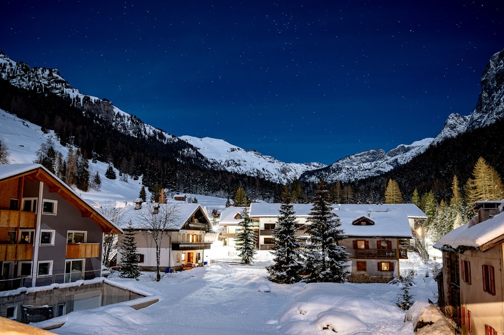 a night time view of a ski resort in the mountains