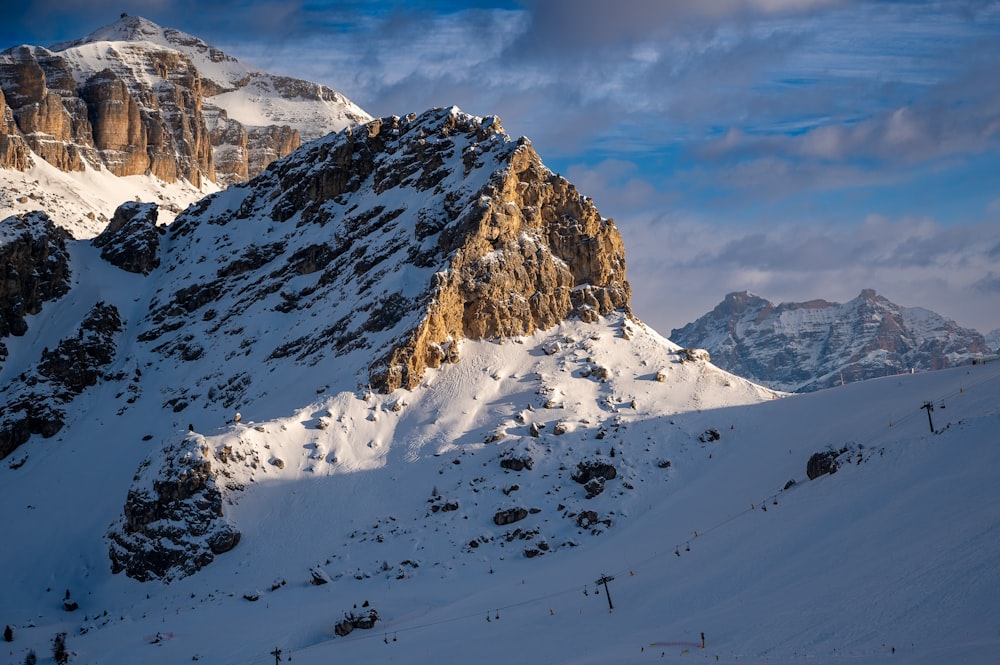 a snow covered mountain with a sky background