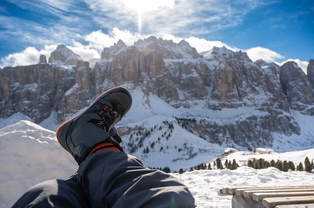 a person sitting on top of a snow covered mountain