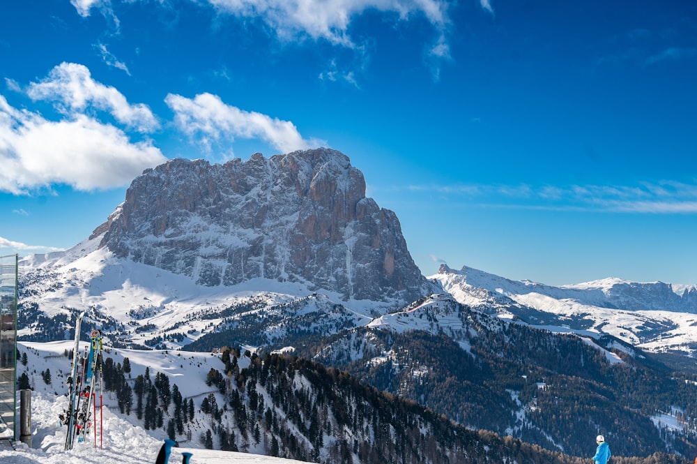 a group of people riding skis on top of a snow covered slope