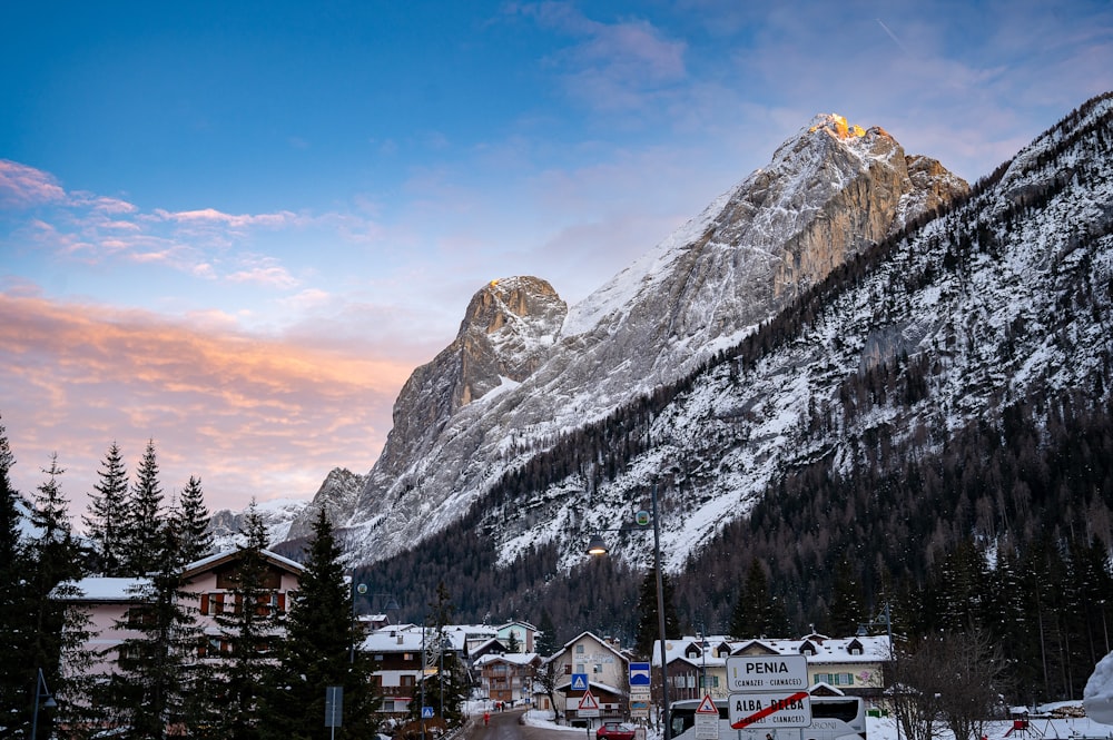 a snowy mountain with a village in the foreground