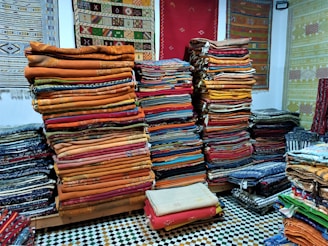 a room filled with lots of different colored fabrics
