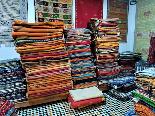 a room filled with lots of different colored fabrics