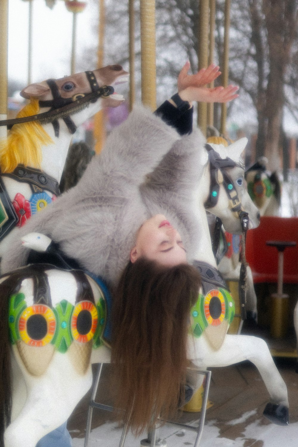 a woman laying on top of a merry go round