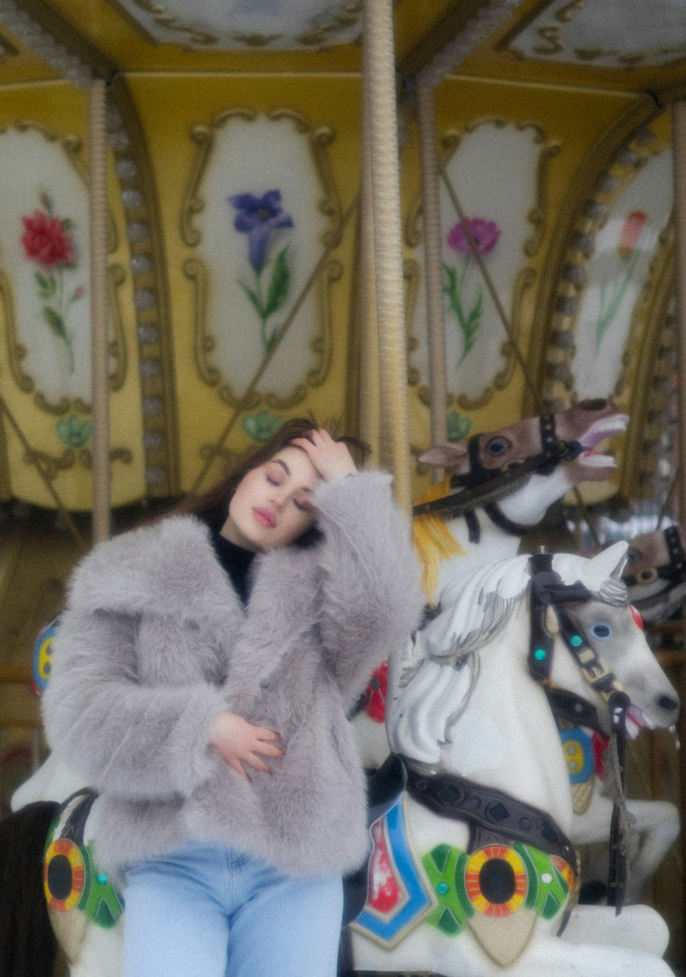 a woman is sitting on a merry go round