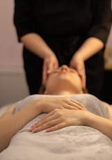 a woman getting a facial massage at a spa