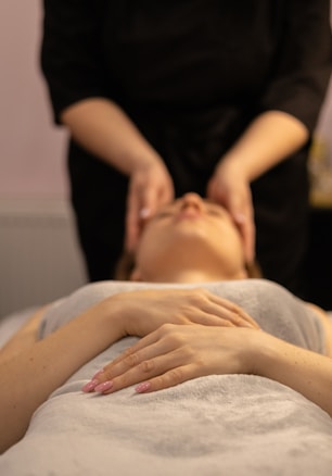 a woman getting a facial massage at a spa