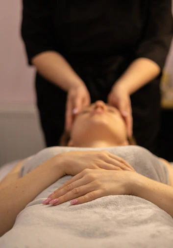 a woman getting a facial massage at a spa