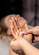 a woman laying on a bed with her hands together