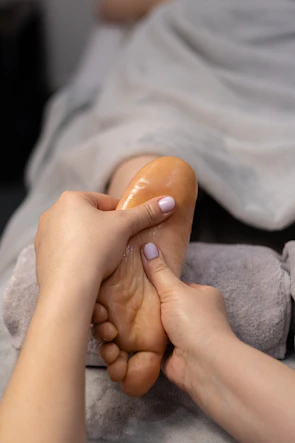 a woman getting a foot massage from an RMT at 2L's in Bowmanville
