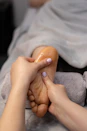a woman getting a foot massage from a foot massager