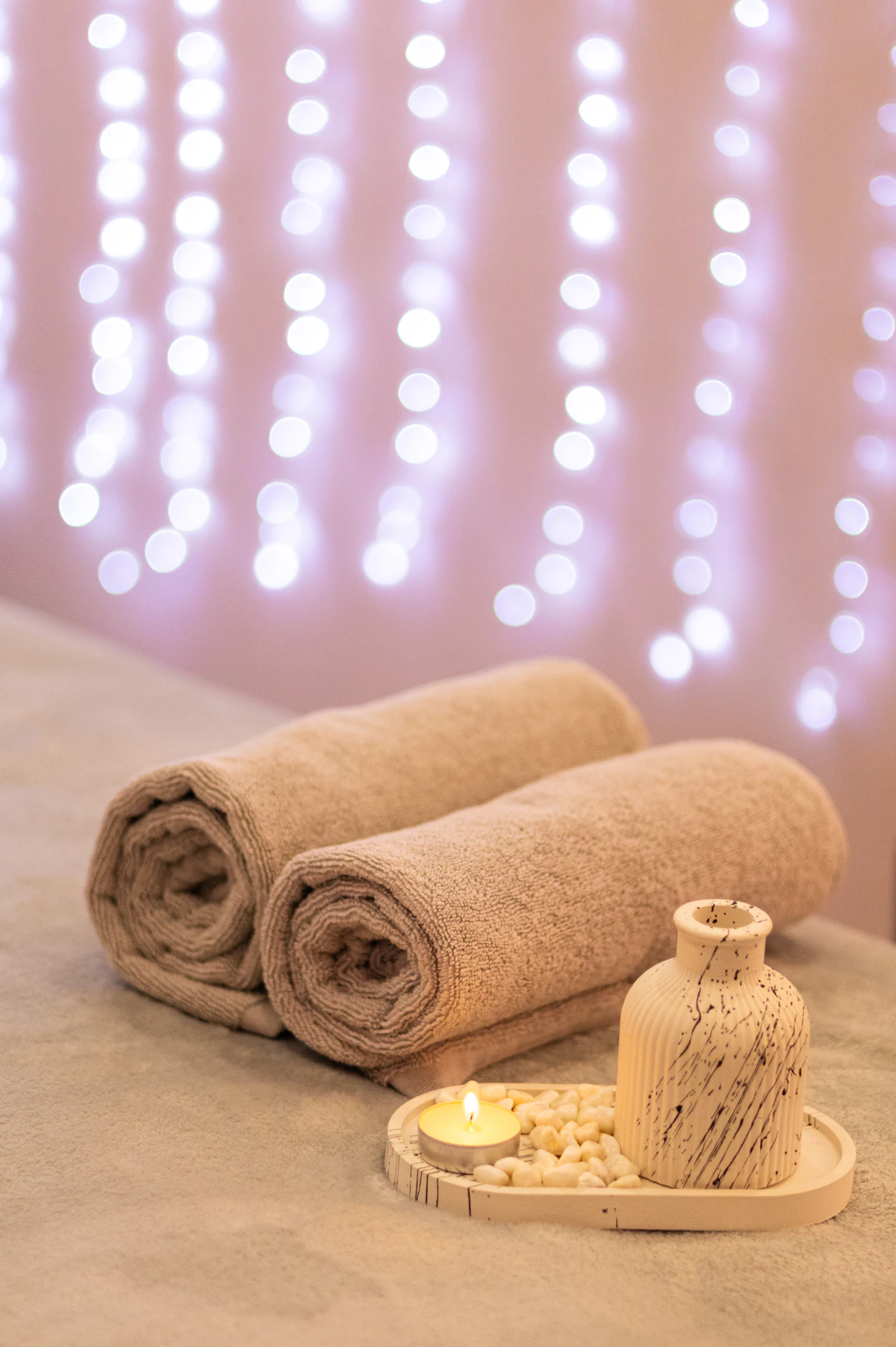 Rolled spa towels in soft warm light
