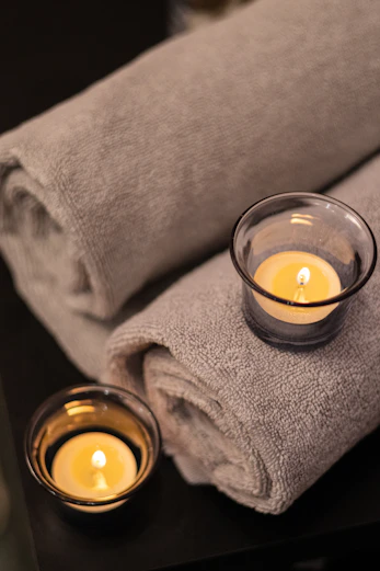 a couple of candles sitting on top of a table