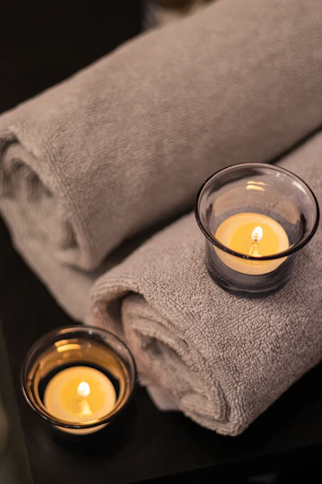 a couple of candles sitting on top of a table