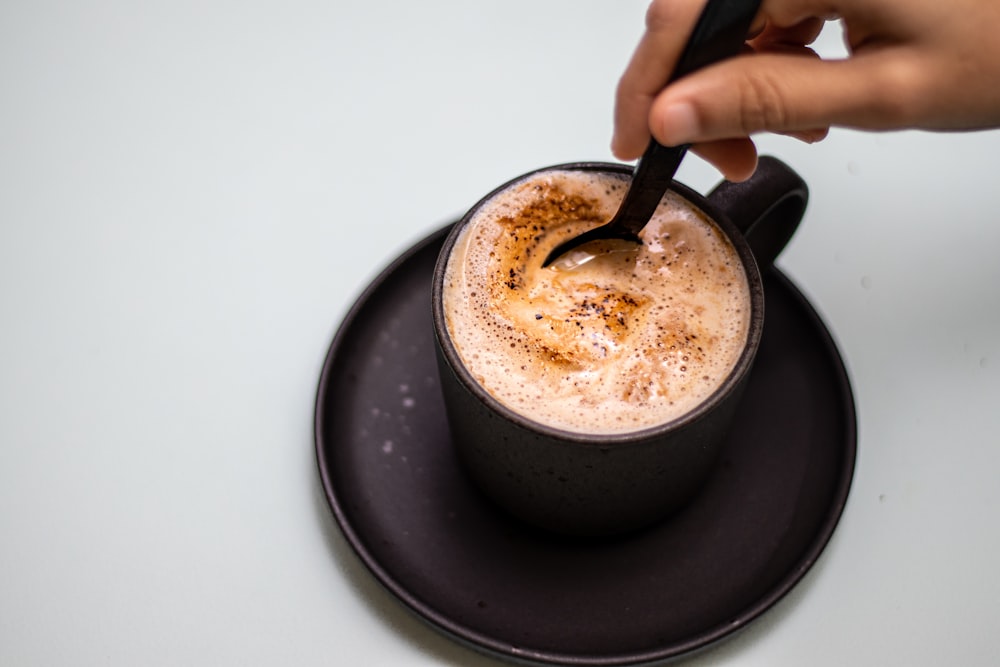 a cup of coffee with a spoon in it